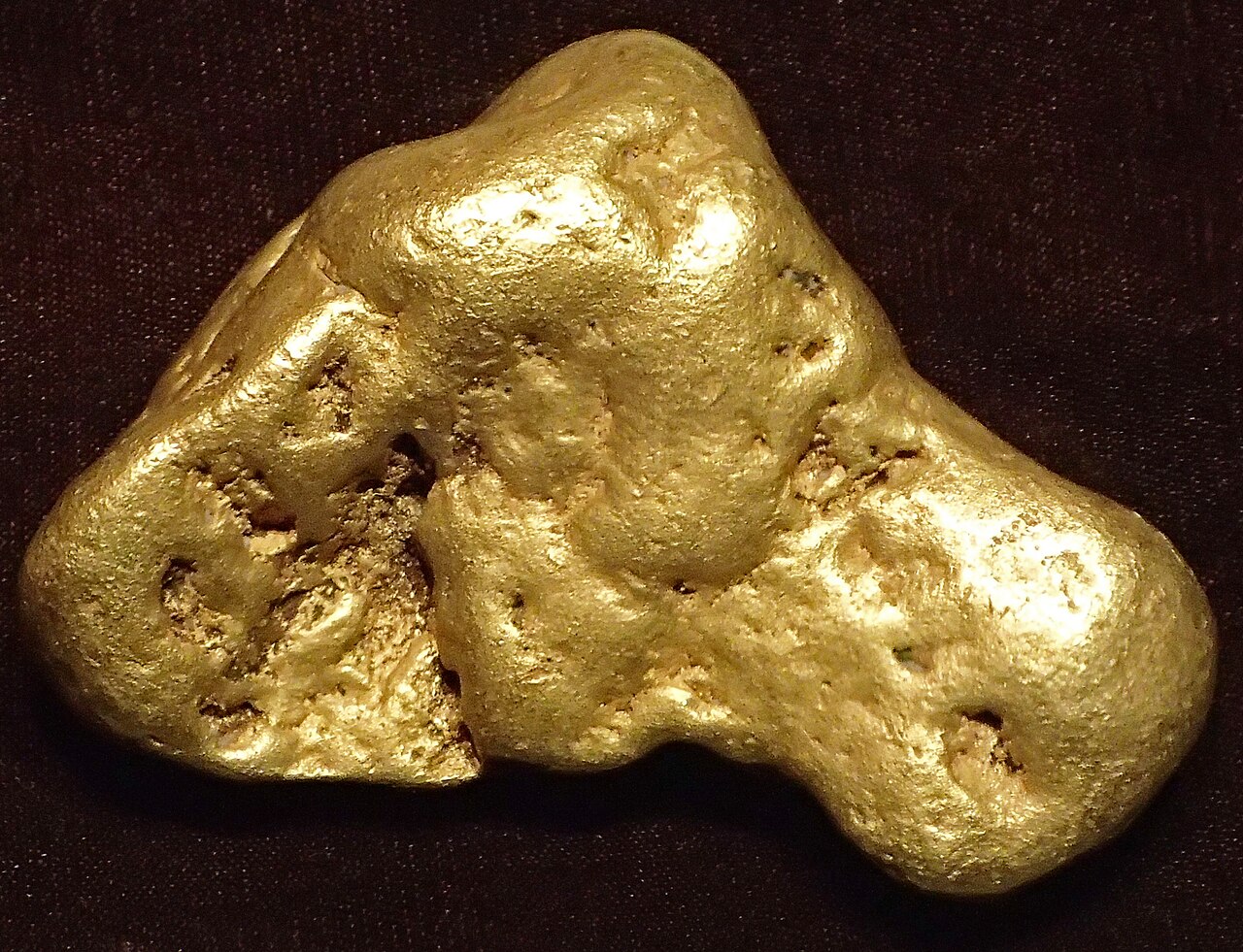 A gold nugget against a dark background